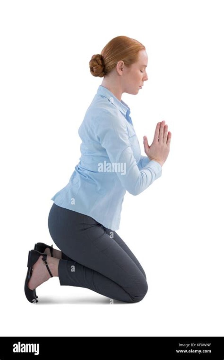a woman kneeling down next to a dog