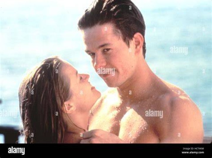 Reese Witherspoon and Mark Wahlberg ride a bike.