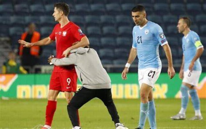 Security guard runs into Polish player as pitch intruder mars Israel