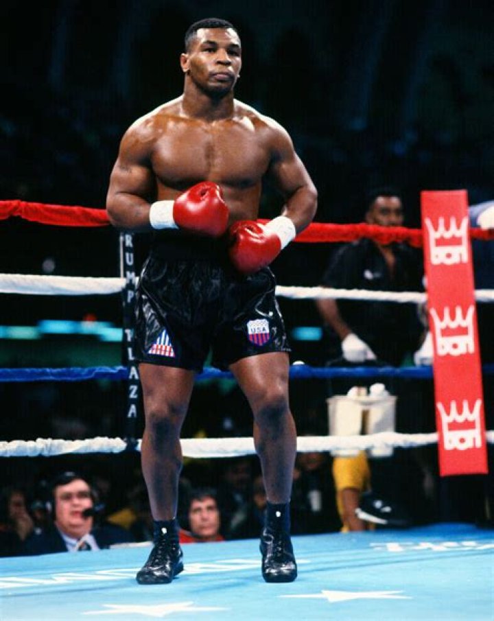 Who was Mike Tyson's adopted father?